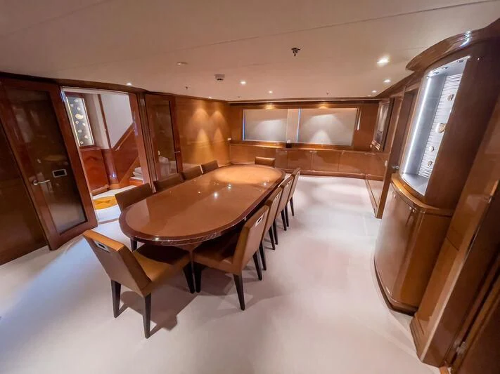 a large room with a table and chairs aboard ALAMSHAR Yacht for Sale