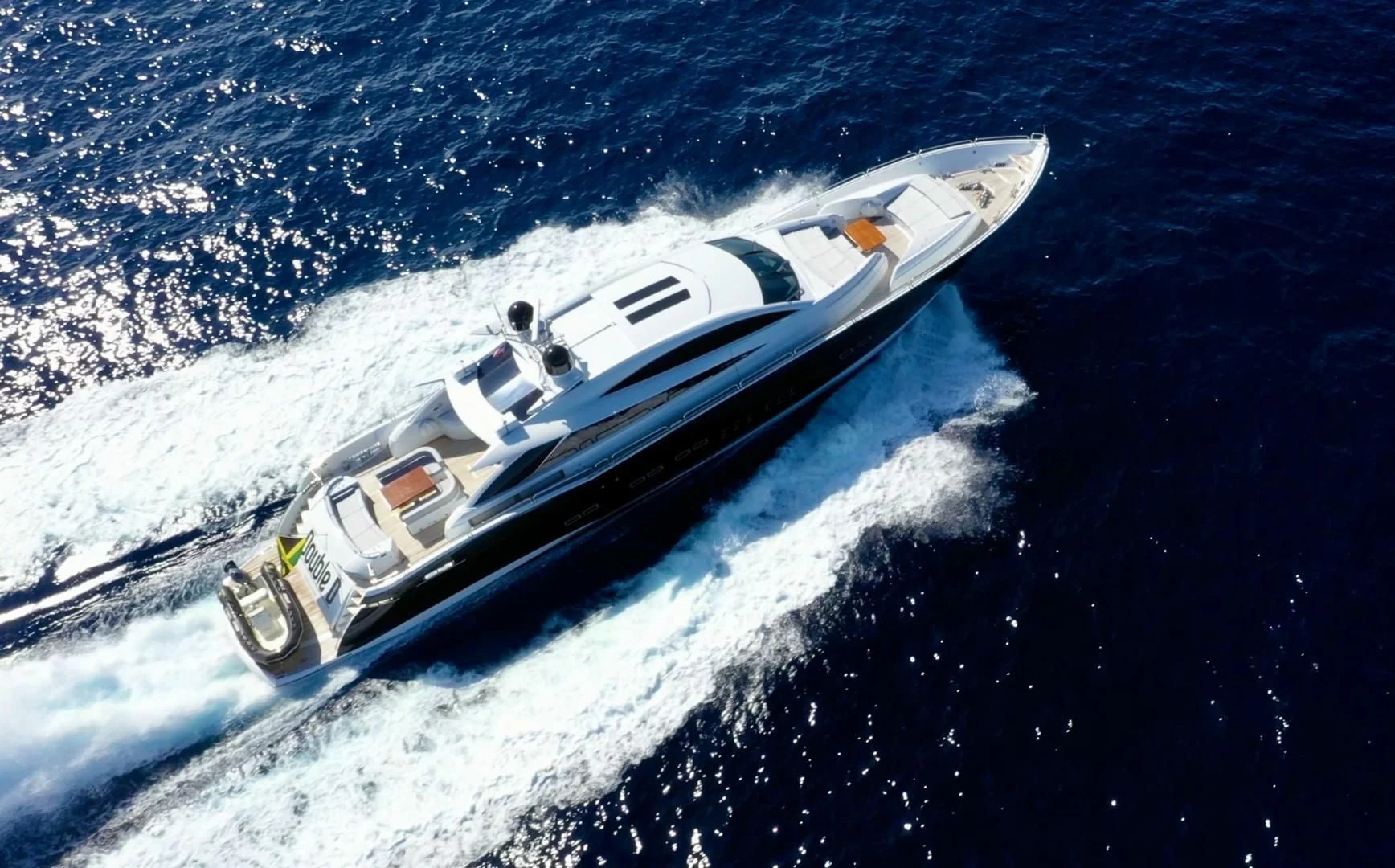 a white boat on a body of water aboard SKY FALL Yacht for Sale
