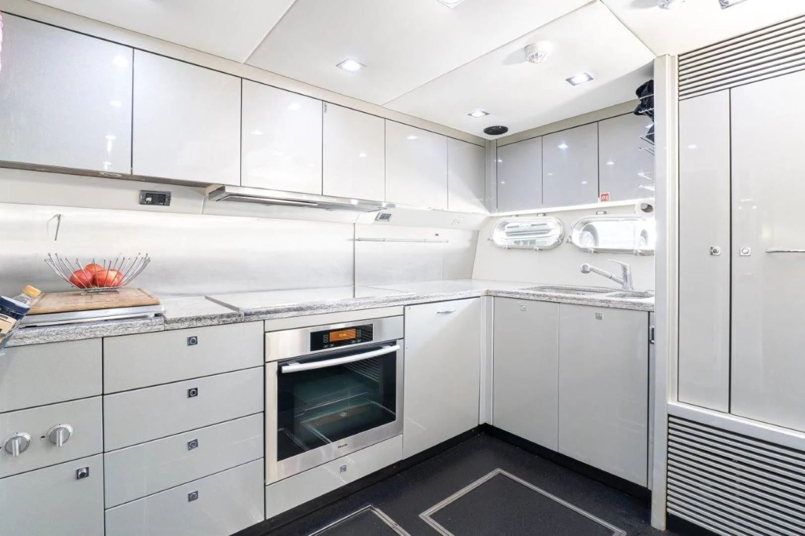 a kitchen with white cabinets aboard SKY FALL Yacht for Sale