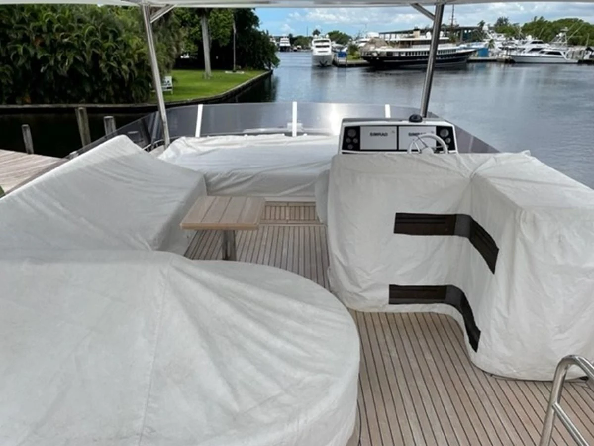 a group of white beds on a deck overlooking a body of water aboard EXIT Yacht for Sale