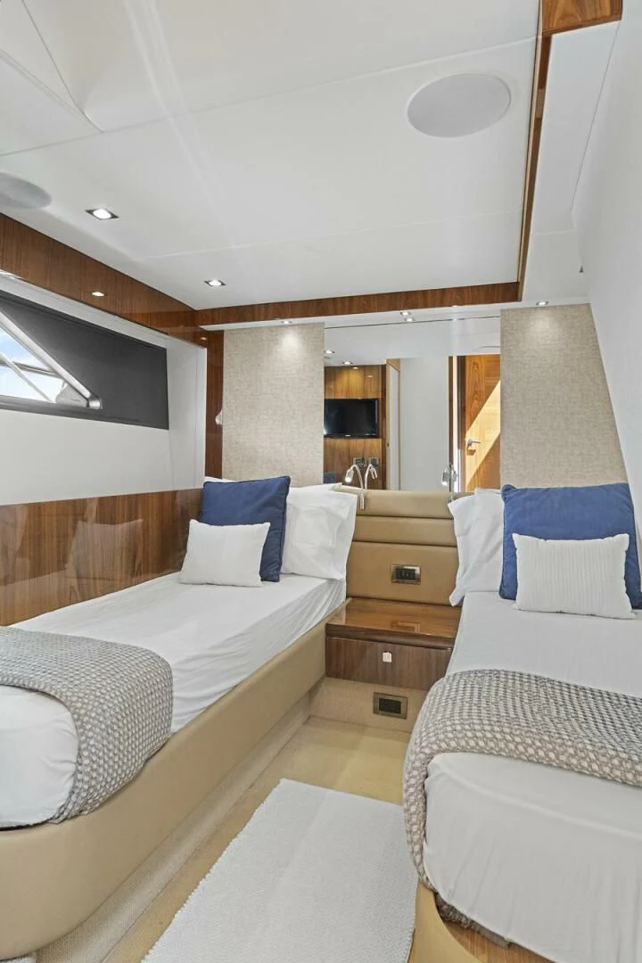 a room with a bed and a dresser aboard EXIT Yacht for Sale