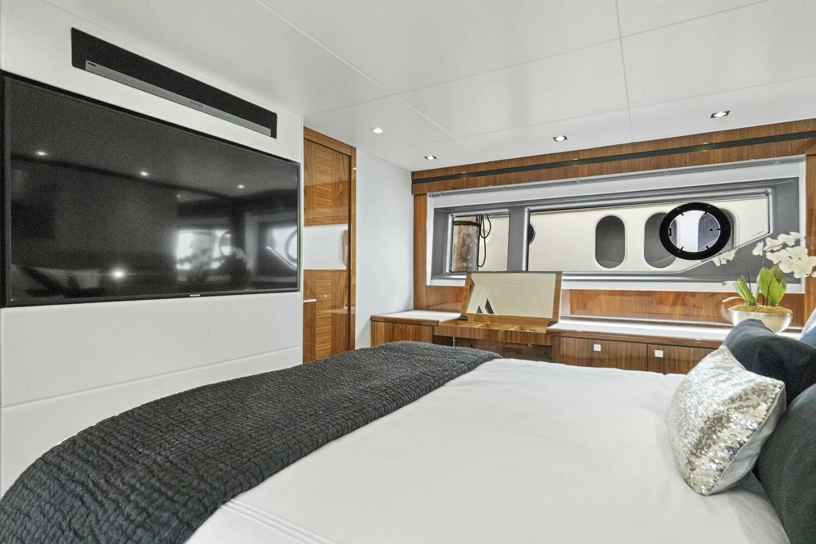 a bedroom with a bed and a fireplace aboard EXIT Yacht for Sale