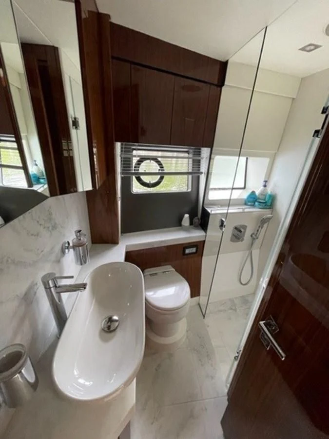 a bathroom with a toilet and a sink aboard EXIT Yacht for Sale