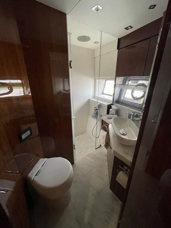 a bathroom with a toilet and a sink aboard EXIT Yacht for Sale
