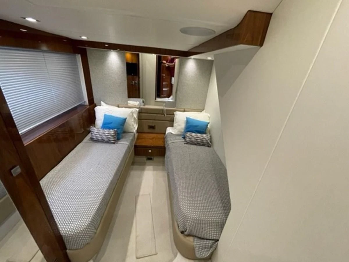 a room with a bed and a chair aboard EXIT Yacht for Sale