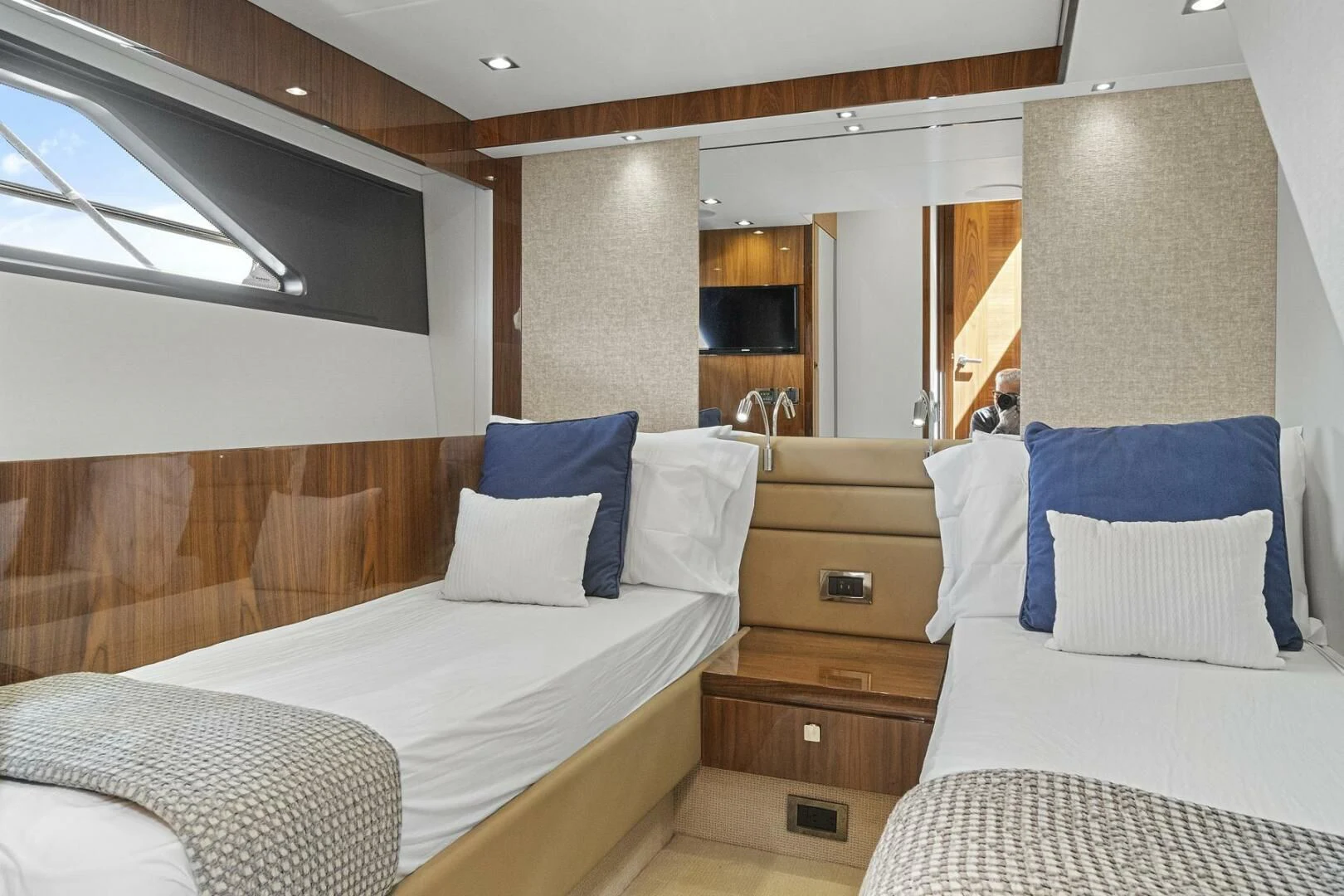 a room with a bed and a television aboard EXIT Yacht for Sale
