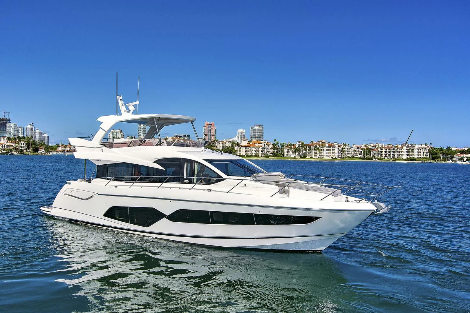 a white yacht on the water aboard EXIT Yacht for Sale