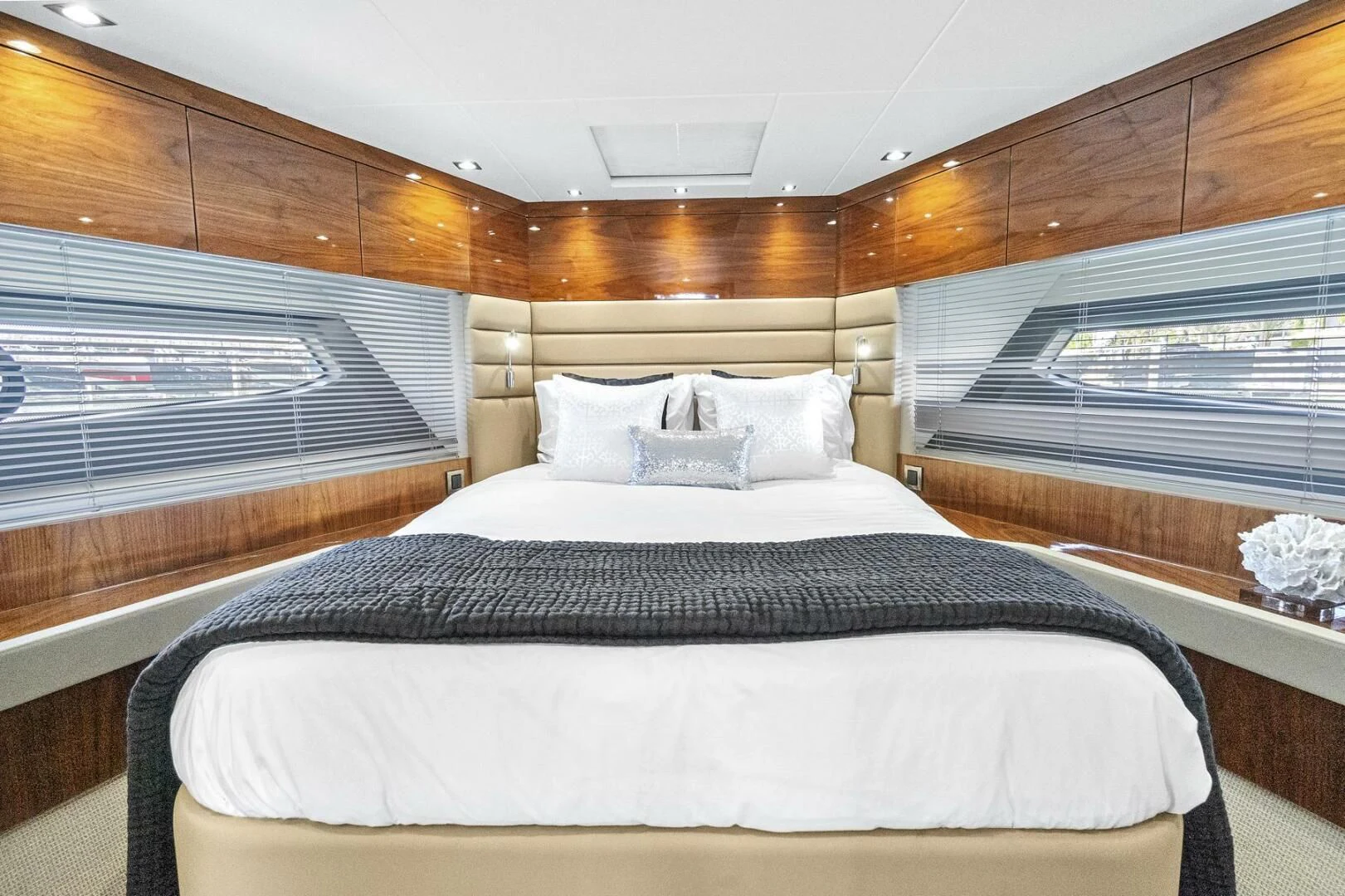 a bed with a black and white bed spread aboard EXIT Yacht for Sale
