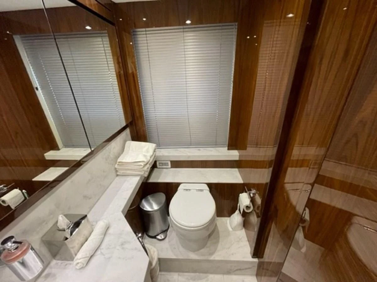 a bathroom with a toilet and a sink aboard EXIT Yacht for Sale