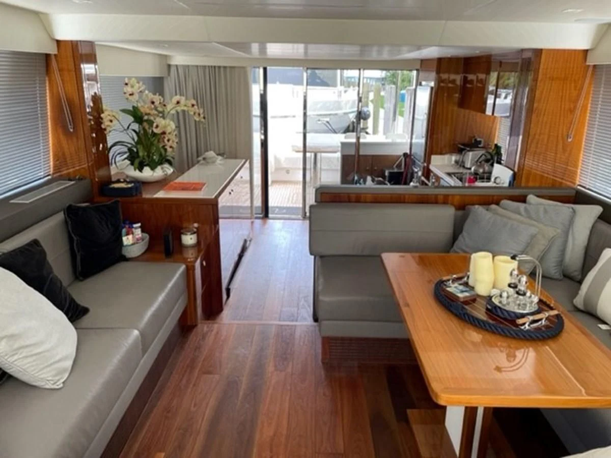 a living room with a couch and a table aboard EXIT Yacht for Sale