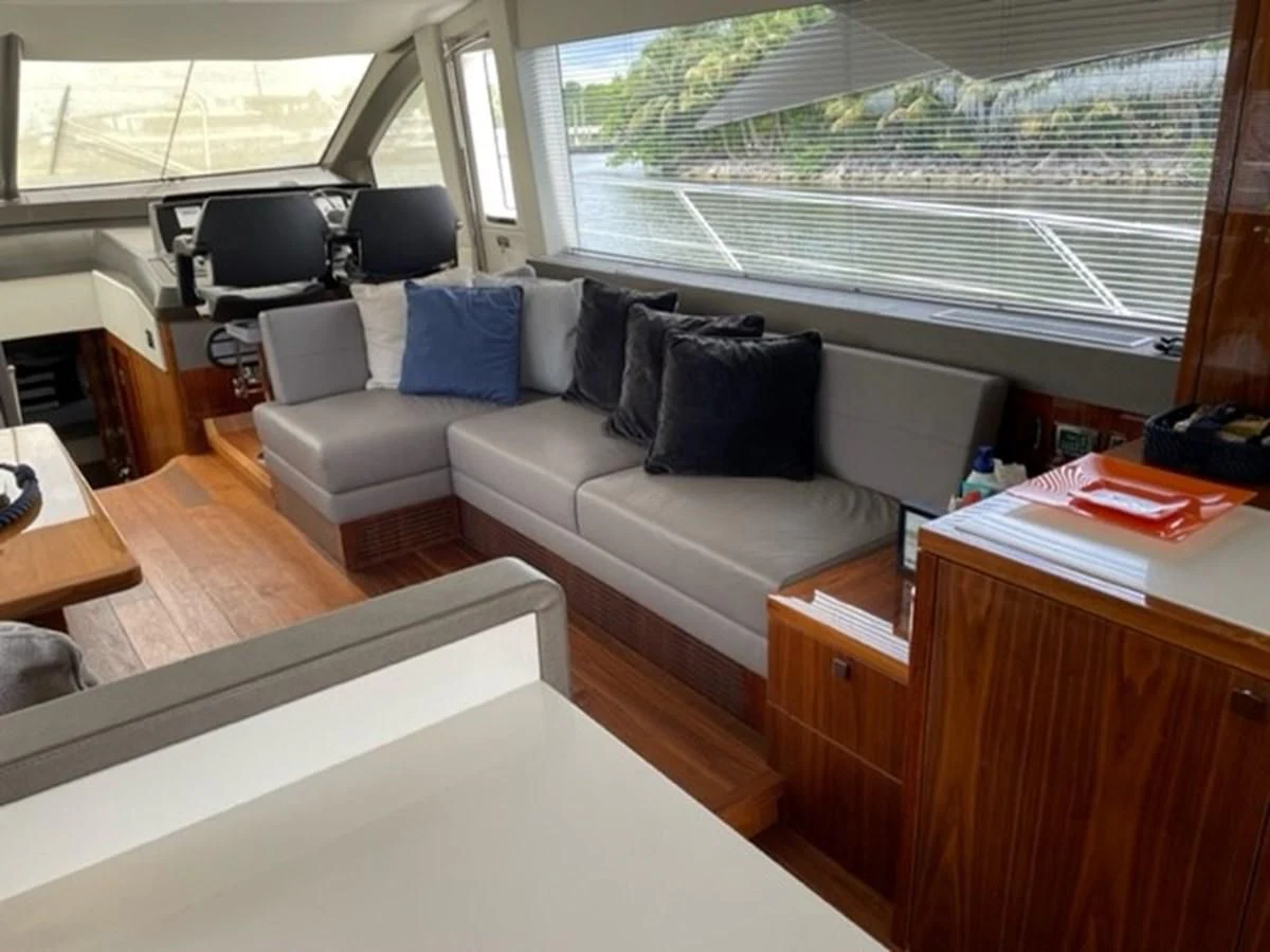 a living room with a couch and a window aboard EXIT Yacht for Sale