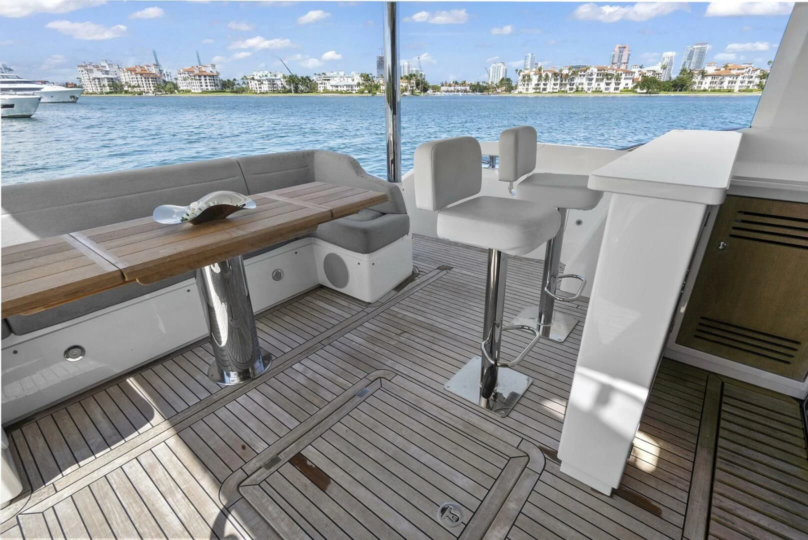 a deck with chairs and a table aboard EXIT Yacht for Sale