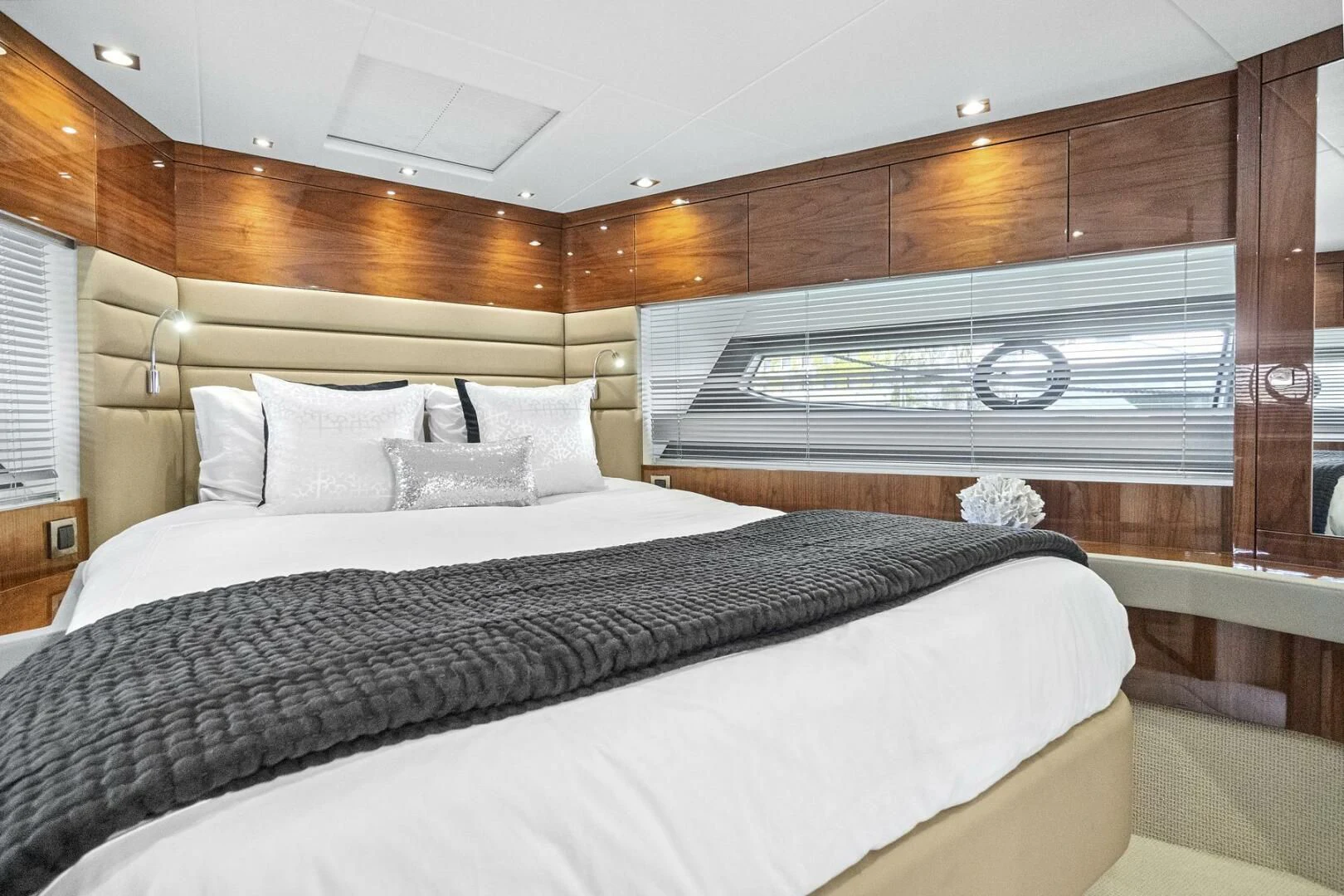 a bed with a white bed spread aboard EXIT Yacht for Sale