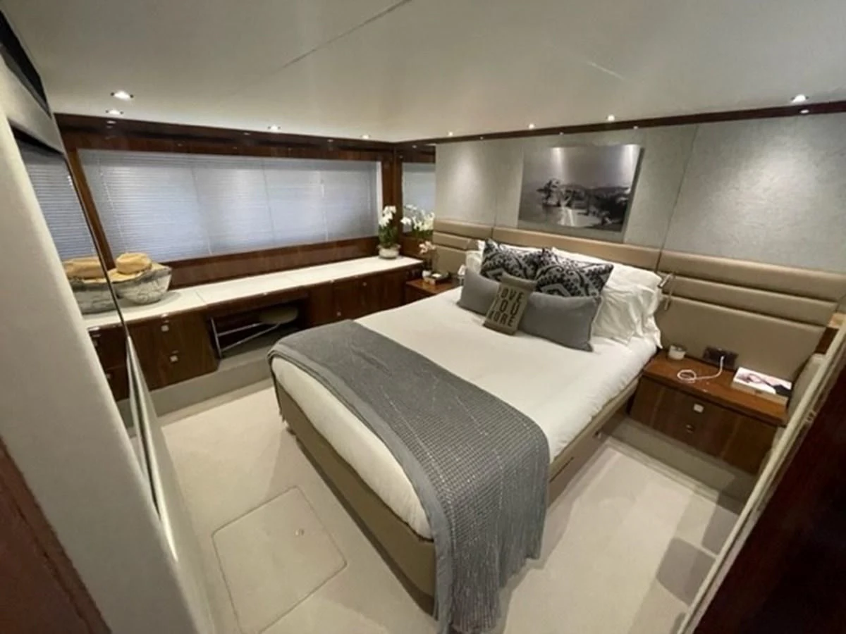 a room with a bed and piano aboard EXIT Yacht for Sale