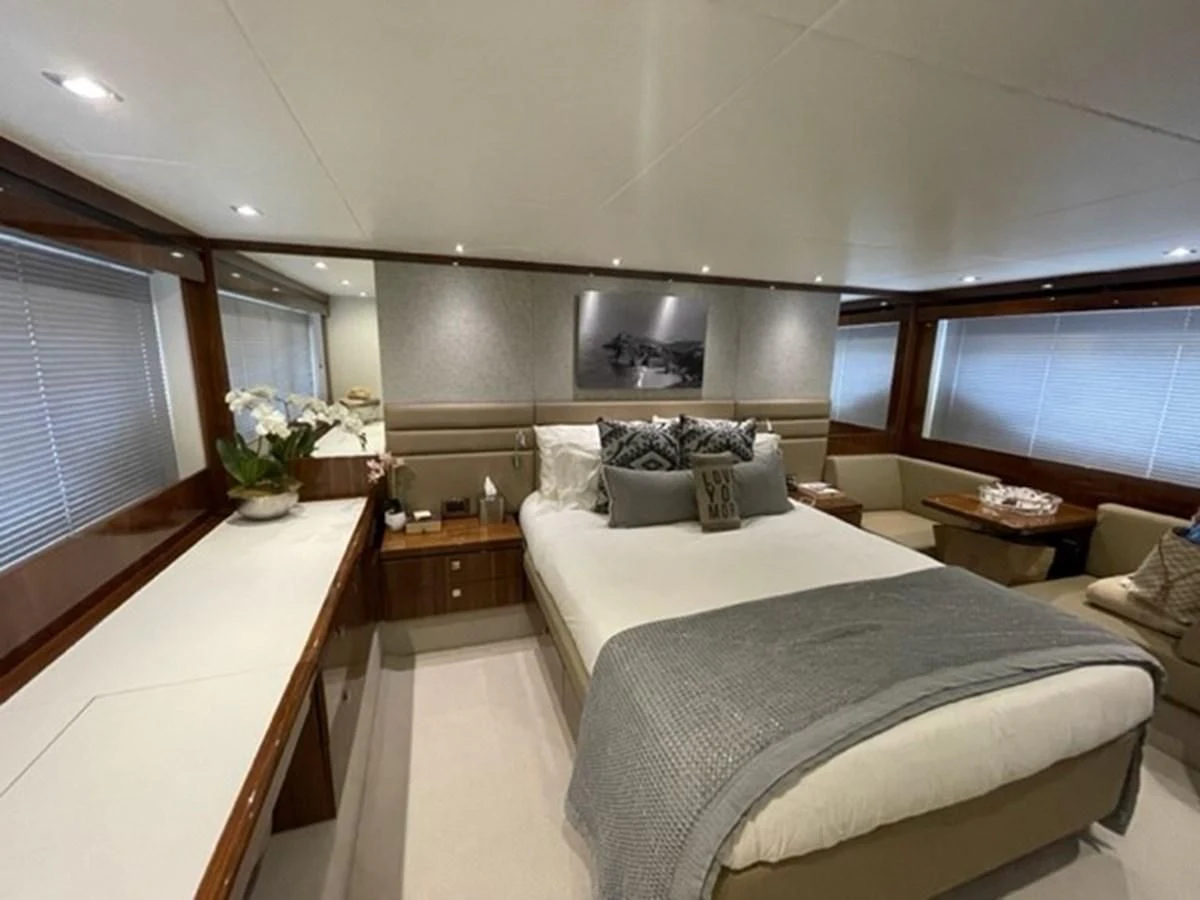 a bedroom with a bed and a table aboard EXIT Yacht for Sale
