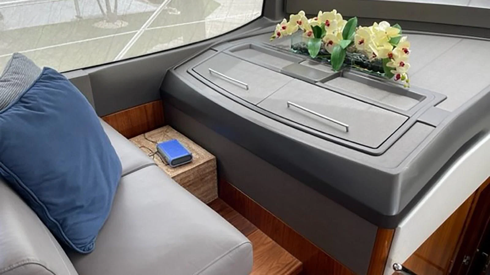 a white rectangular table with a blue pillow on it aboard EXIT Yacht for Sale