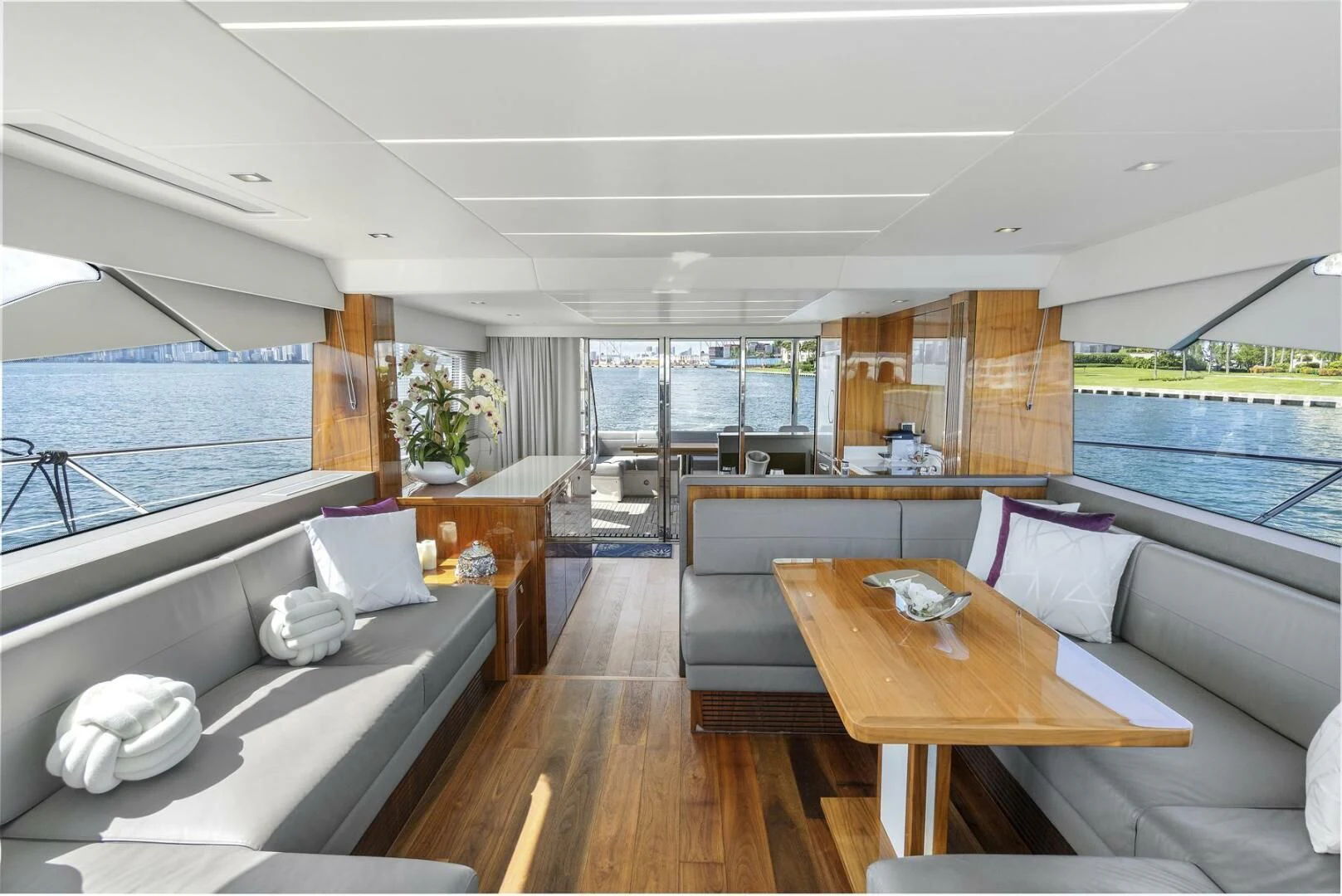 a room with a bed and a table and a couch aboard EXIT Yacht for Sale