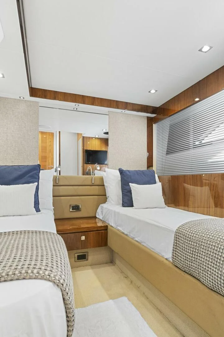 a room with a bed and a dresser aboard EXIT Yacht for Sale