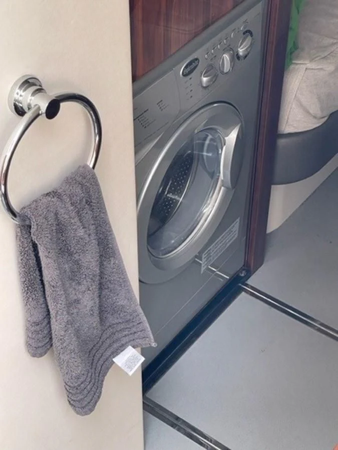 a washer and dryer in a bathroom aboard EXIT Yacht for Sale