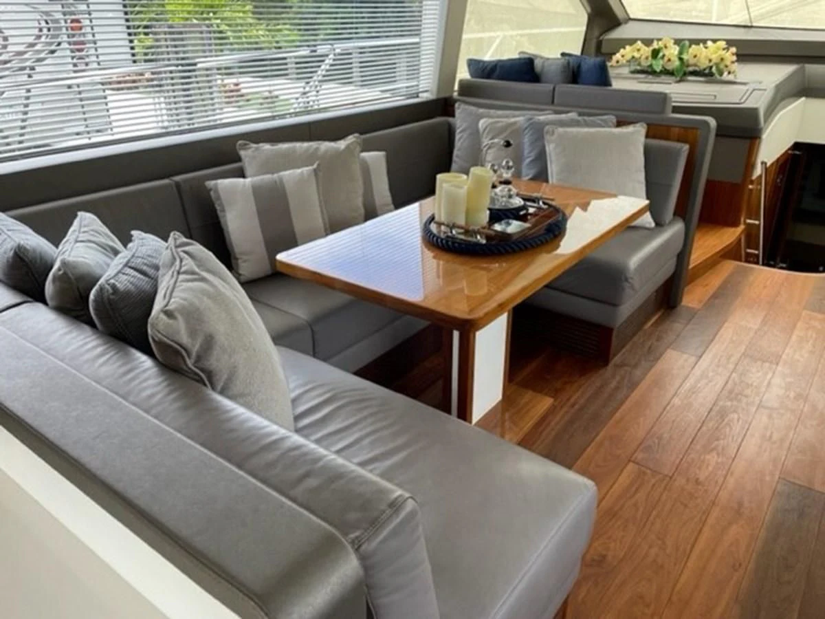 a living room with a couch and a coffee table aboard EXIT Yacht for Sale