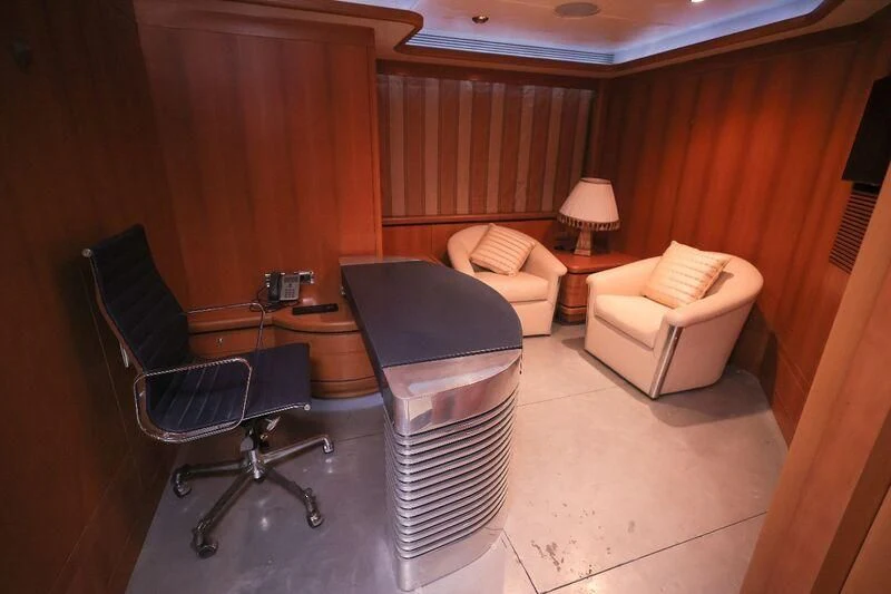 a room with a table and chairs aboard OCEAN 1 Yacht for Sale