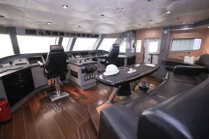 a room with a table and chairs aboard OCEAN 1 Yacht for Sale