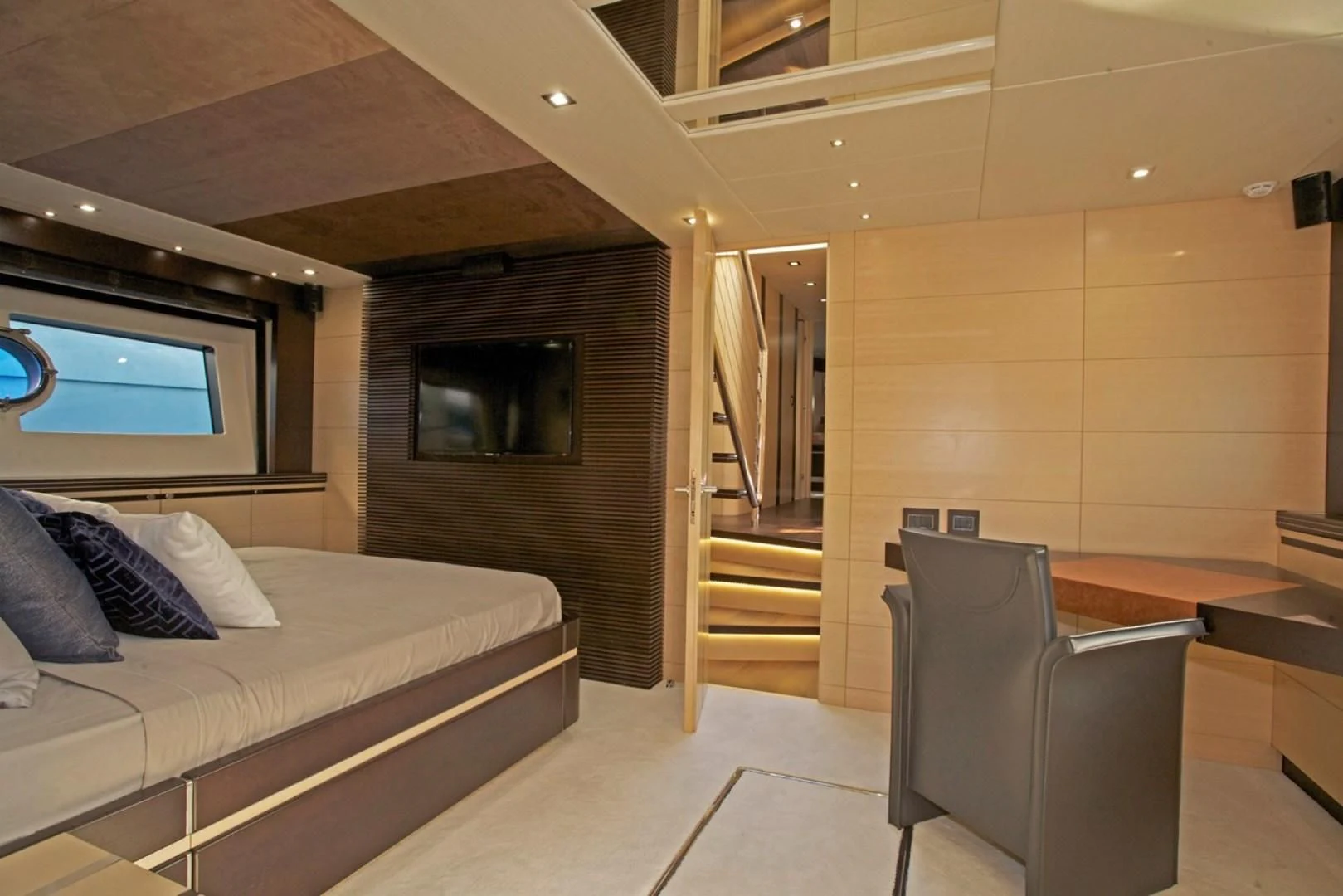 a bedroom with a bed and a chair aboard WOODEVER Yacht for Sale
