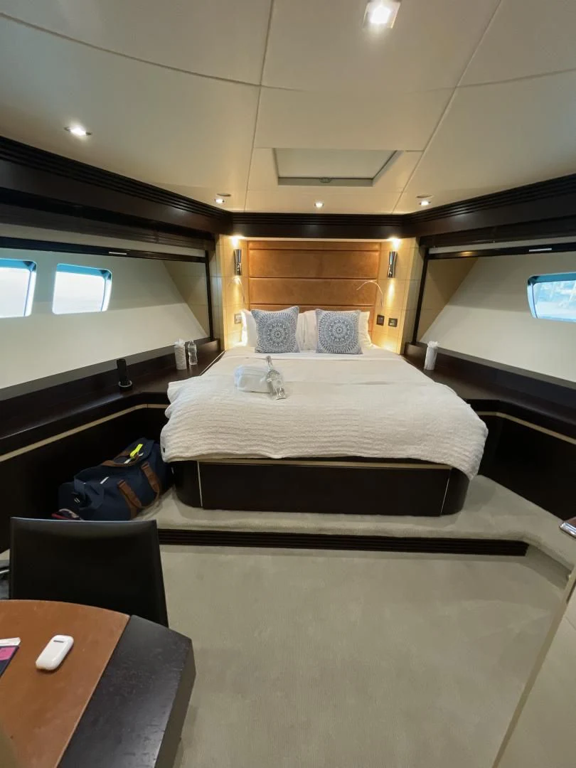 a bed with a table and chairs aboard WOODEVER Yacht for Sale