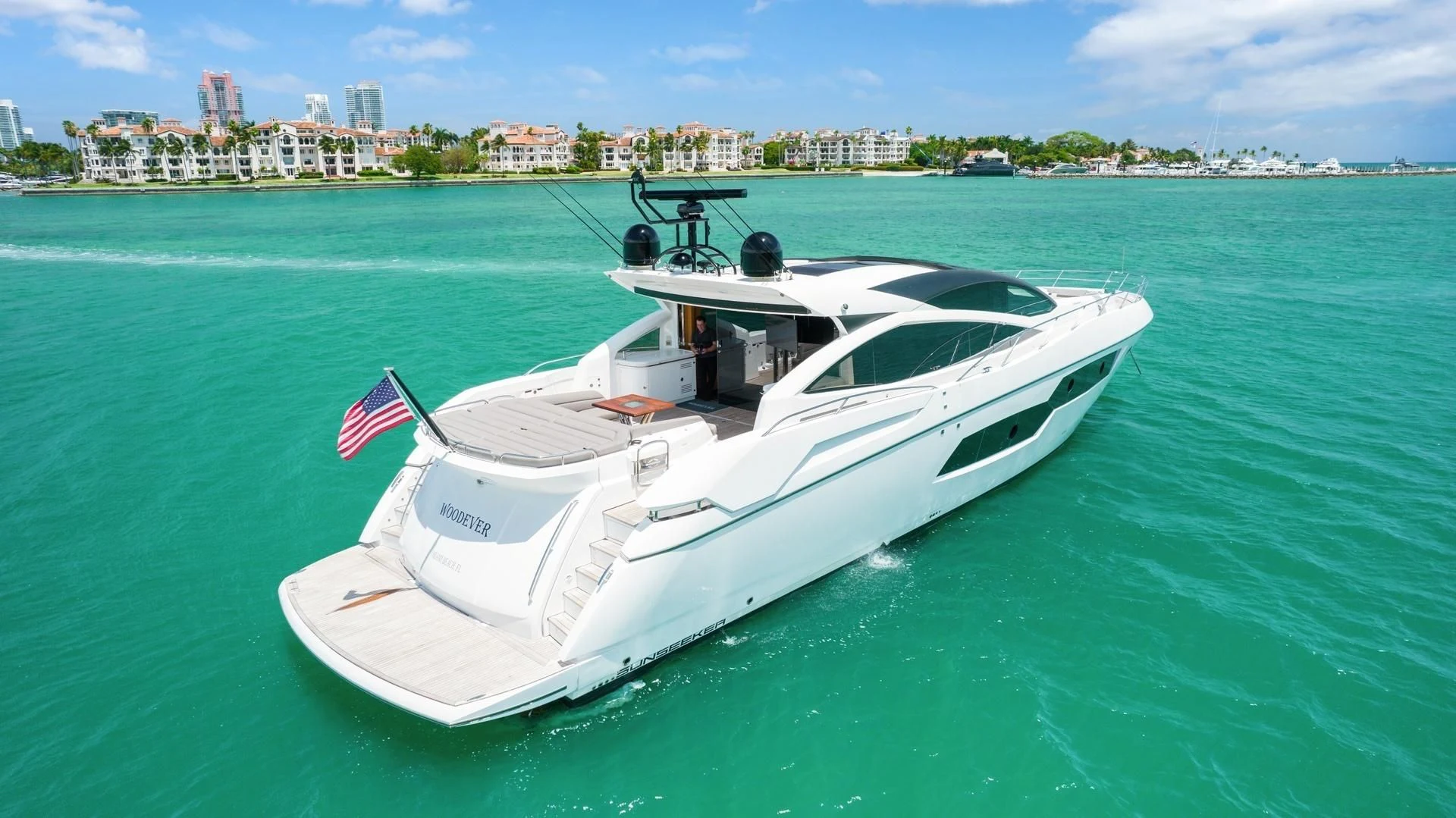 a white boat on the water aboard WOODEVER Yacht for Sale