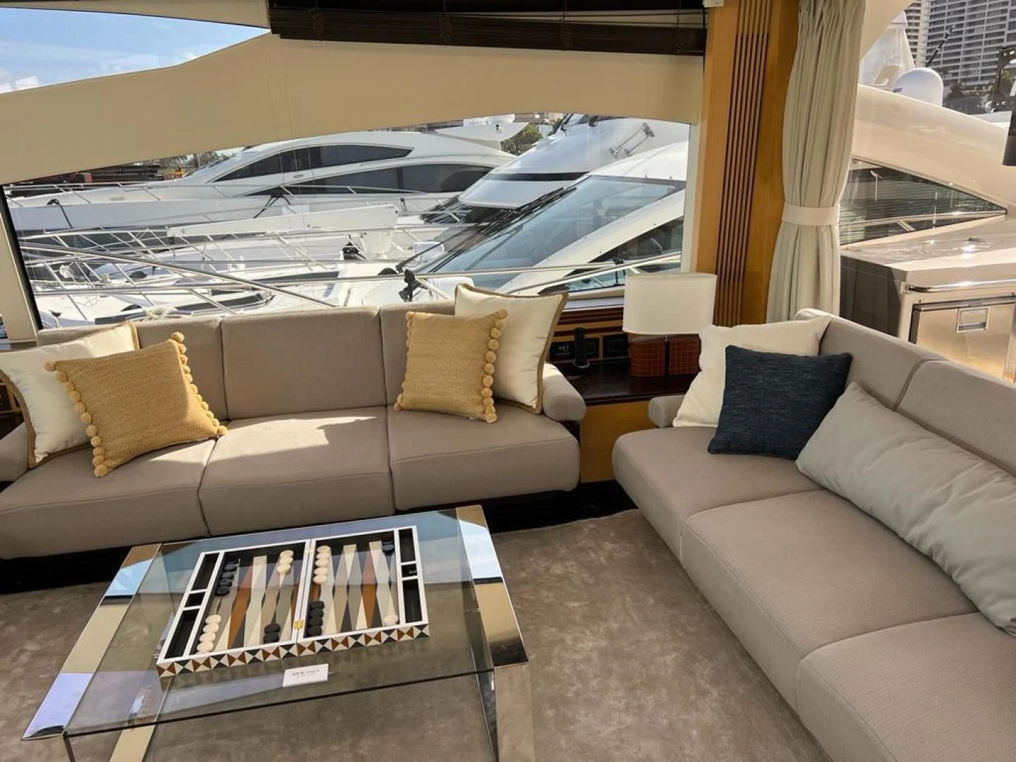 a couch and a table in a room with a large window aboard WOODEVER Yacht for Sale