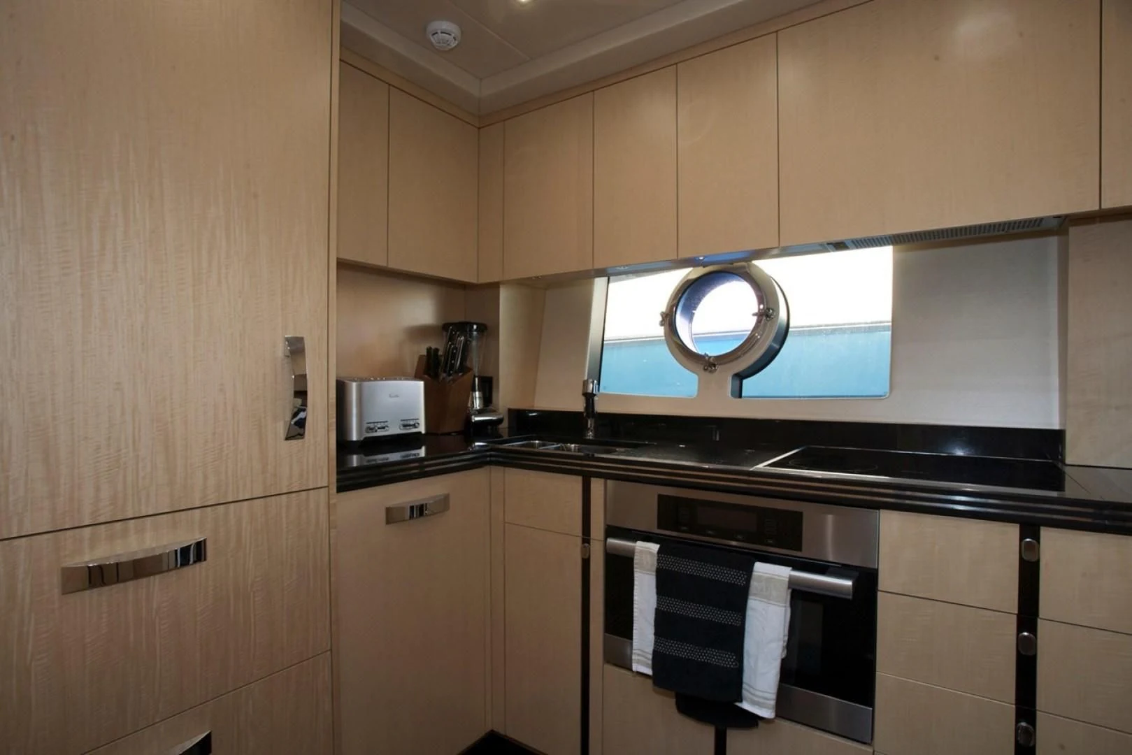 a kitchen with a microwave oven and cabinets aboard WOODEVER Yacht for Sale