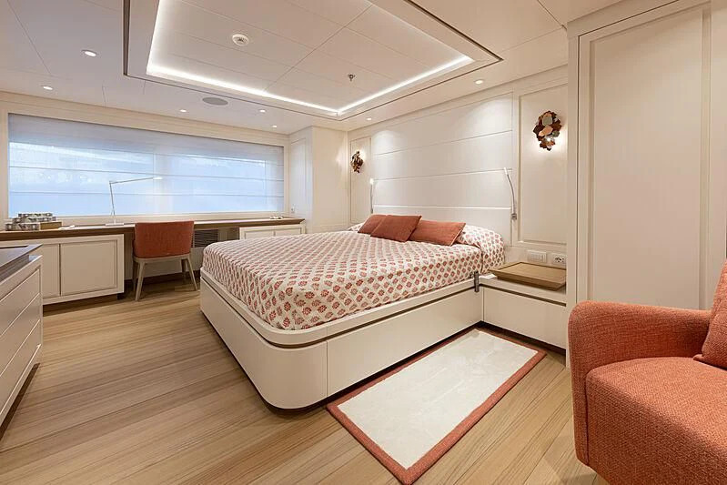 a bedroom with a bed and a couch aboard FRAMURA Yacht for Sale