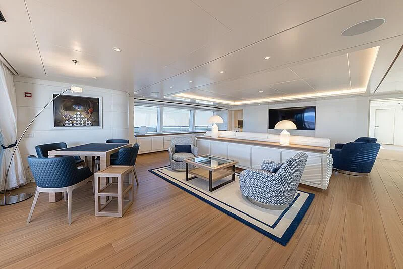 a living room with a pool table and chairs aboard FRAMURA Yacht for Sale