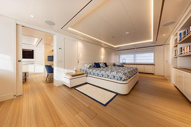 a large living room with a blue rug aboard FRAMURA Yacht for Sale