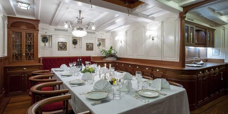 a dining room with a table set aboard ATLANTIC Yacht for Charter