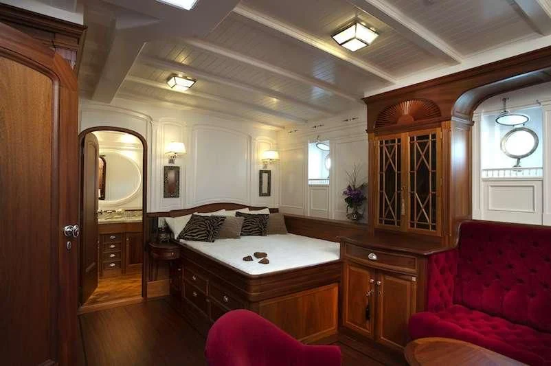 a bedroom with a bed and a couch aboard ATLANTIC Yacht for Charter