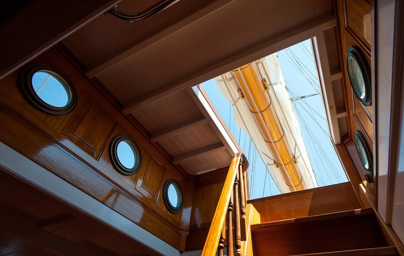 a staircase with a clock aboard ATLANTIC Yacht for Charter