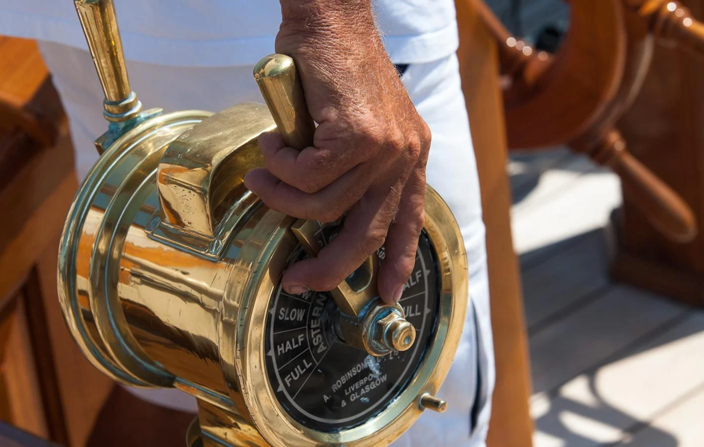 a close-up of a hand holding a golden trophy aboard ATLANTIC Yacht for Charter