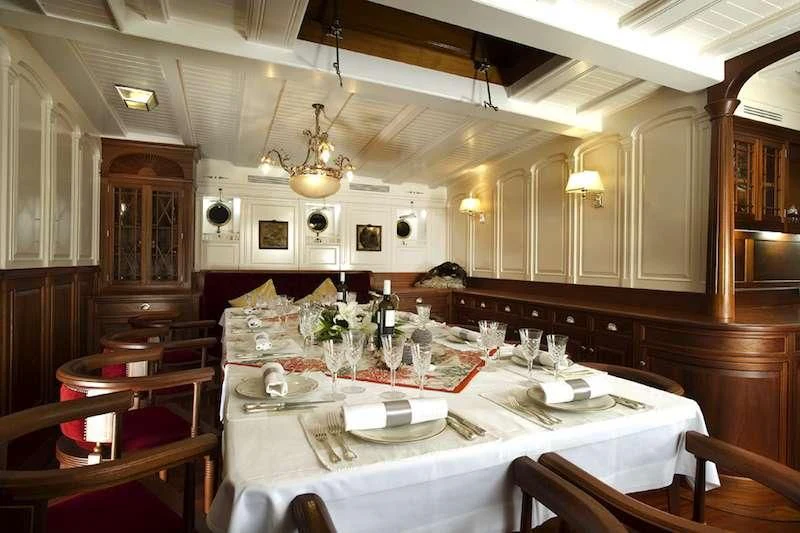 a dining room with tables and chairs aboard ATLANTIC Yacht for Charter