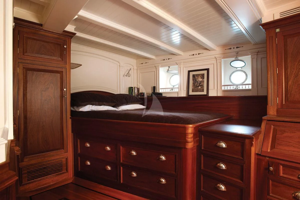 a bedroom with a bed and a dresser aboard ATLANTIC Yacht for Charter