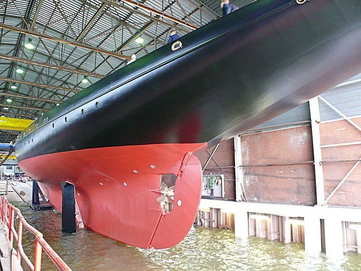 a large red airplane in a hangar aboard ATLANTIC Yacht for Charter