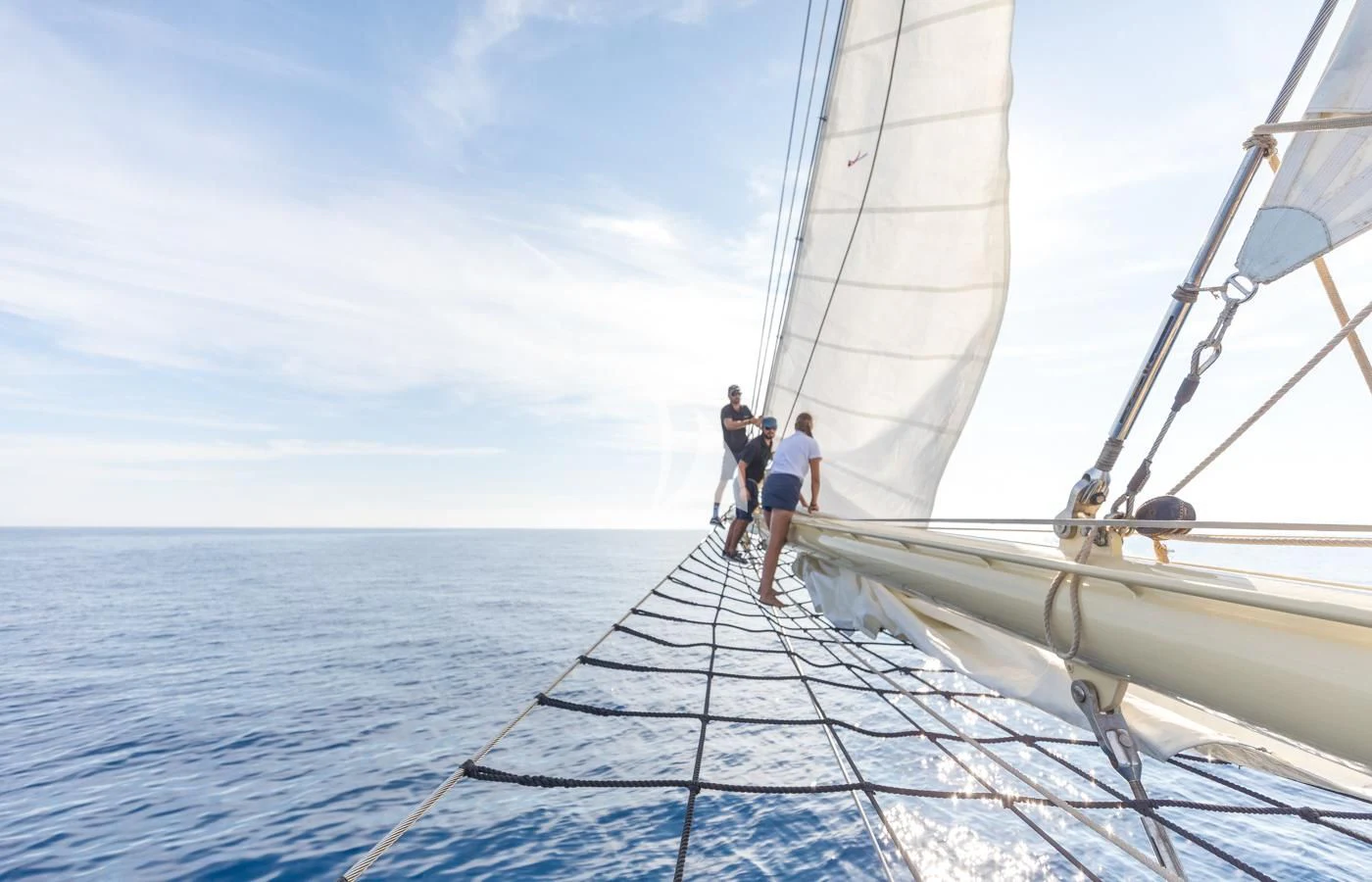a couple of people walking on a boat in the water aboard ATLANTIC Yacht for Charter