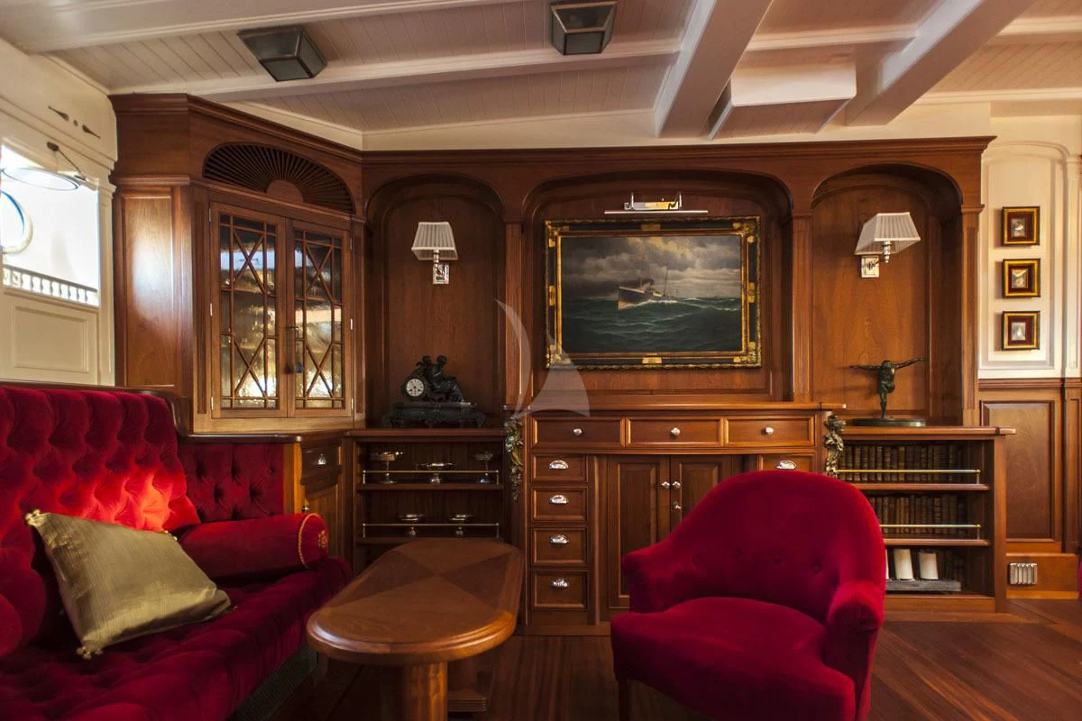 a living room with a tv and a bookcase aboard ATLANTIC Yacht for Charter