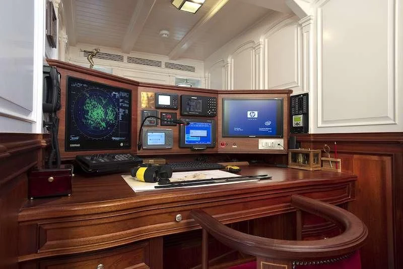 a desk with computers and monitors aboard ATLANTIC Yacht for Charter