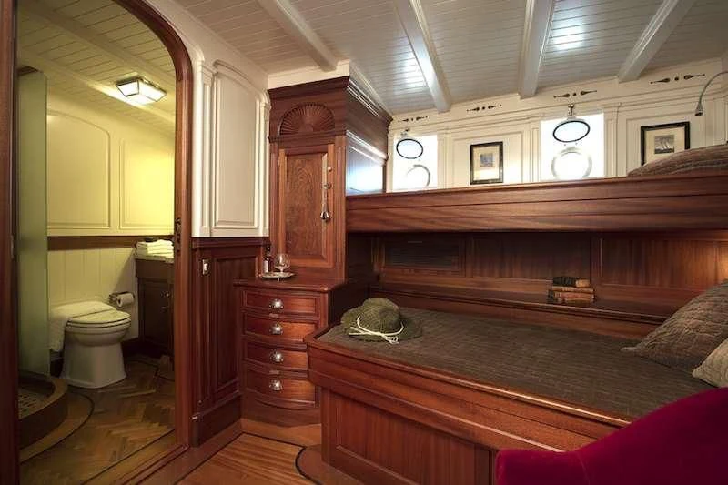 a bedroom with a bed and a dresser aboard ATLANTIC Yacht for Charter