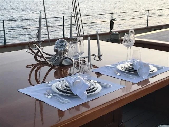 a table with silverware and silverware on it aboard ATLANTIC Yacht for Charter