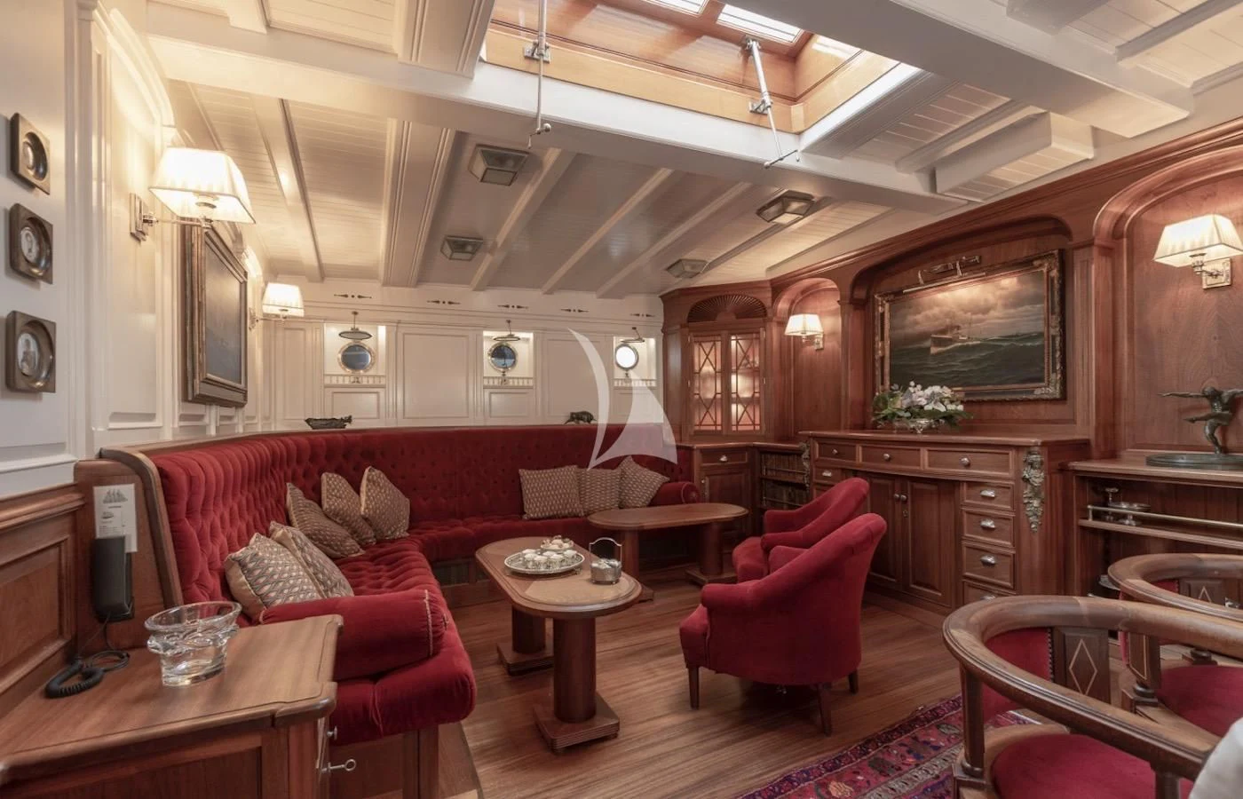 a living room with red furniture aboard ATLANTIC Yacht for Charter