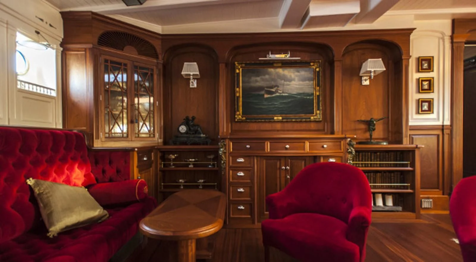 a living room with a red couch and a television aboard ATLANTIC Yacht for Charter