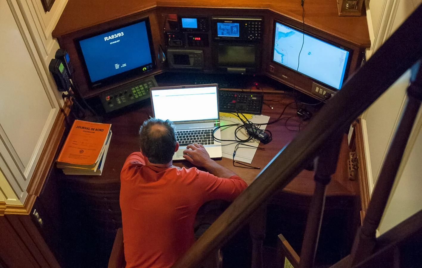 a person sitting in front of a computer aboard ATLANTIC Yacht for Charter