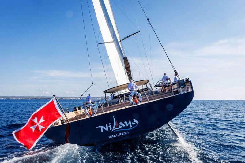 a boat with a flag on it aboard NILAYA Yacht for Sale